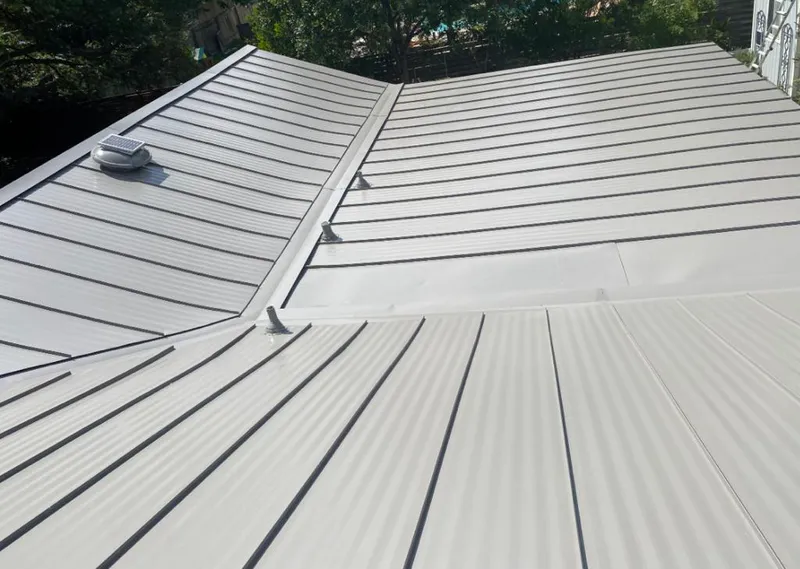 Solar attic fan installed on a metal roof for Roof Ventilation in Pineville